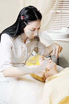 Beautician makes threading hair removal