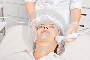 Beautician makes ultrasound skin tightening for rejuvenation woman face using phonophoresis