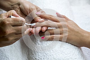 Beautician nail treatment.Beautiful hands of woman.