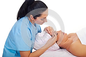 Beautician plucking woman eyebrow