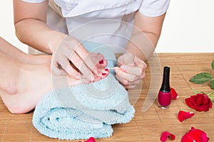 Beautician polishing nails Foot care treatment and nail woman at beautician for pedicure in beauty spa