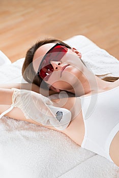 Beautician Removing Hair Of Woman With Epilator photo