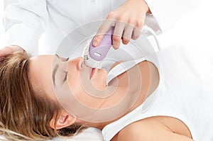 Beautician removing hair of woman`s leg. Laser epilation