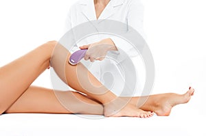 Beautician removing hair of woman`s leg. Laser epilation