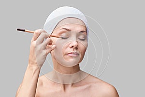 Beautician skin care. Face pencil make up. Facial treatment. Woman dermatology