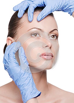 Beautician touch and exam health woman face