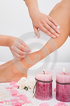 Beautician waxing a woman's leg photo