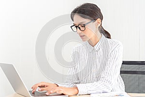 Beautif; caucasian businesswoman working on laptop typing in modern home office. Smart businesswomen happy smiling on her work