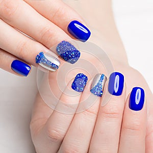 Beautifil blue manicure with rhinestone. Nail Design. Close-up photo