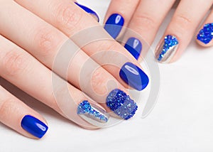 Beautifil blue manicure with rhinestone. Nail Design. Close-up