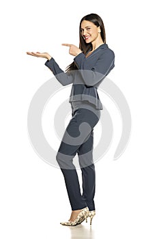 Beautifu advertizing business woman in a pants and jacke