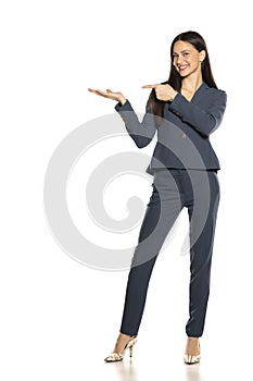 Beautifu advertizing business woman in a pants and jacket