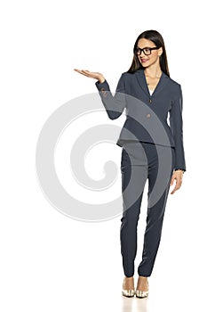 Beautifu advertizing business woman in a pants and jacket