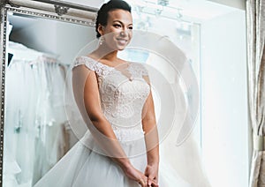 Beautifu bride choosing wedding dress in a wedding salon