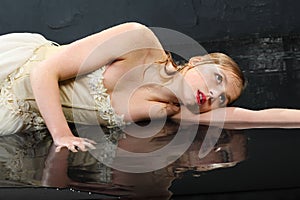 Beautifu girl lies on wet floor