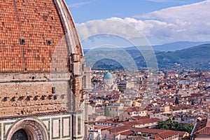 Beautifu view of city skyline, towers, basilicas, red-tiled roofs of houses and mountains, Florence, Italy
