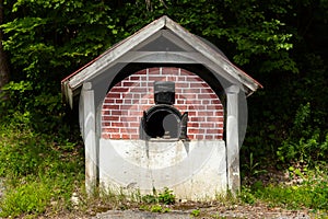 Beautiful 19th century historic traditional outdoor brick bread oven with metal doors