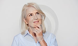 Beautiful 50 years old blonde woman is looking up and dreaming