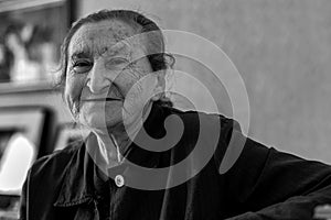 Beautiful 80 plus year old senior woman portrait. Black and white image of elderly woman smiling.