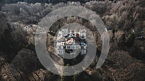 Beautiful abandoned manor at sunset. Tall trees. Beautiful sunlight. Old abandoned building.