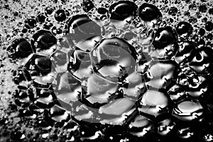 Beautiful abstract foam white bubbles on dark black background and soap black bubble and detergent