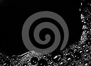 Beautiful abstract foam white bubbles on dark black background and soap black bubble and detergent