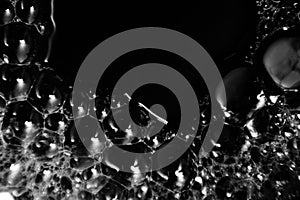 Beautiful abstract foam white bubbles on dark black background and soap black bubble and detergent
