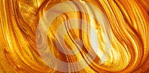 Beautiful abstract golden liquid paint background, beauty gold backdrop texture. Metallic gold paint