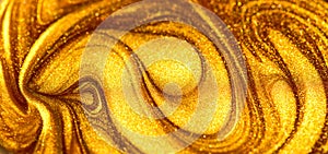 Beautiful abstract golden liquid paint background, beauty gold backdrop texture. Metallic gold paint