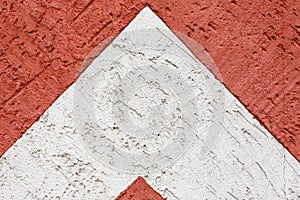 Beautiful abstract grunge decorative dark red and white stucco wall background. The shape of an arrow, a triangle. Art Rough