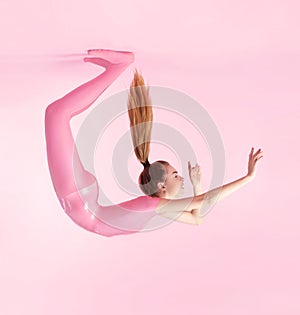 Beautiful acrobatic woman in pink latex costume photo