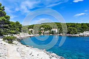 Beautiful Adriatic sea in Croatia. Blue lagoon  green pines  stony coast. Footpath along the sea.Bright landscape