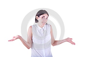 A beautiful and adult girl spreads out her hands in misunderstanding and shrugs shoulders, isolated on the white background.