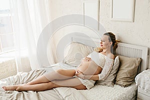 Beautiful adult pregnant woman. Waiting for the baby. Pregnancy. Care, tenderness, motherhood, childbirth.