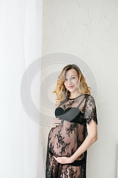 Beautiful adult pregnant woman. Waiting for the baby. Pregnancy. Care, tenderness, motherhood, childbirth.