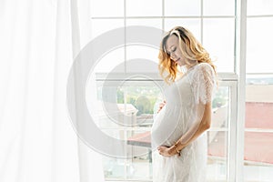 Beautiful adult pregnant woman. Waiting for the baby. Pregnancy. Care, tenderness, motherhood, childbirth.