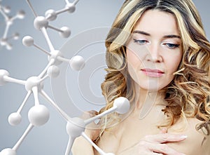 Beautiful adult woman near big white molecule chain.