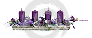 Beautiful advent wreath with four purple candles and various ornaments isolated on white background with shadow reflection.