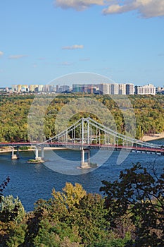 Beautiful aerial cityscape of Kyiv at sunny autumn day. Trukhaniv island with green trees.