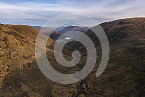 Beautiful aerial drone landscape image of sunrise Winter view from Red Screes in Lake District looking towards Brothers Water and