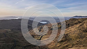 Beautiful aerial drone landscape image of sunrise Winter view from Red Screes in Lake District looking towards Windermere in the