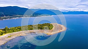 Beautiful aerial establishing birdseye view of baltic sea coast on a sunny evening, sunset, golden hour, beach with white sand,