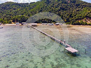 Beautiful aerial image of long wooden jetty with turquoise sea water at Kuala Abai, Kota Belud, Sabah, Borneo