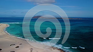 Beautiful aerial panning clip of Flag Beach and Isla de Lobos island