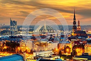 Beautiful aerial panorama of Riga center and Vansu bridge over Daugava river during amazing sunset. View of illuminated Riga city