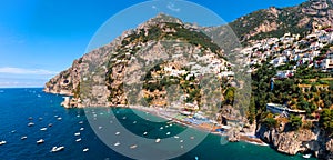 Beautiful aerial panorama view of Positano bay. Rocky shores and incredible beaches, Luxury yachts, boats and apartments