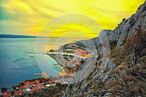 Beautiful aerial panoramic view of Cetina river, mountains and Old town Omis at sunset