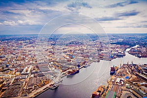 Beautiful aerial panoramic view of the Neva River with some ships in a port with surrounding of some buildings of the