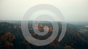 Beautiful aerial shot of mysterious ancient Turaida castle museum in Sigulda national park reserve foggy forest Latvia.