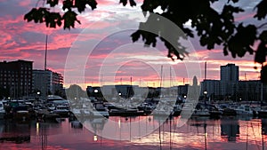 Beautiful aerial sunset view over the docks with many luxury yachts docked by the pier.